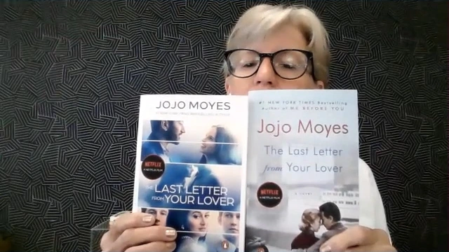 Sarah Bagby holds up two different copies of The Last Letter from Your Lover by Jojo Moyes