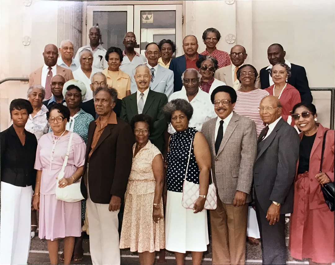A photograph with 29 African American men and women standing on stairs. Chester Lewis is in the front row, third from right.