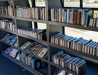 Books on shelves inside the Book Bus